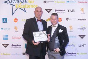 Ronnie Ronalde and Chris Dickinson collecting the award